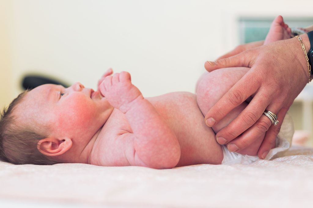 Gentle hands-on care with newborn baby